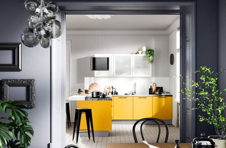 cocina en L con armarios bajos de color amarillo, paredes y suelo blancos