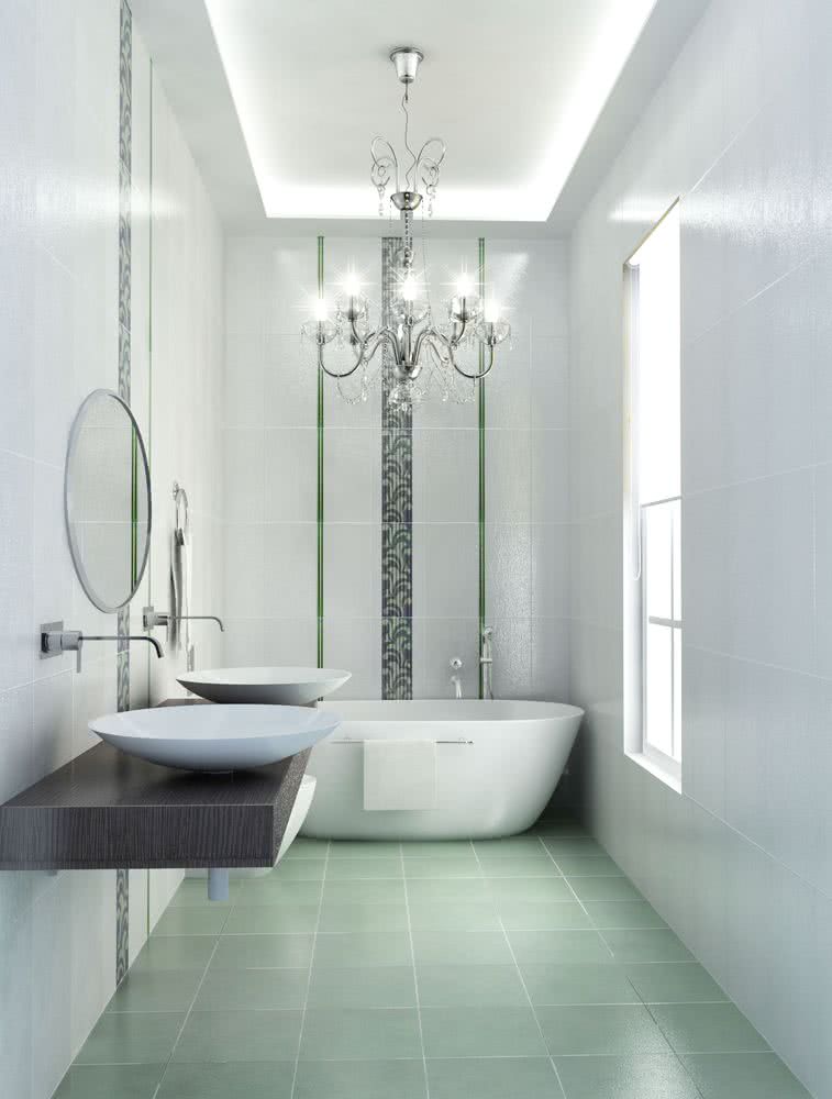 baño alargado con paredes blancas y franjas decorativas, bañera al fondo, suelo verde pastel, encimera flotante negra